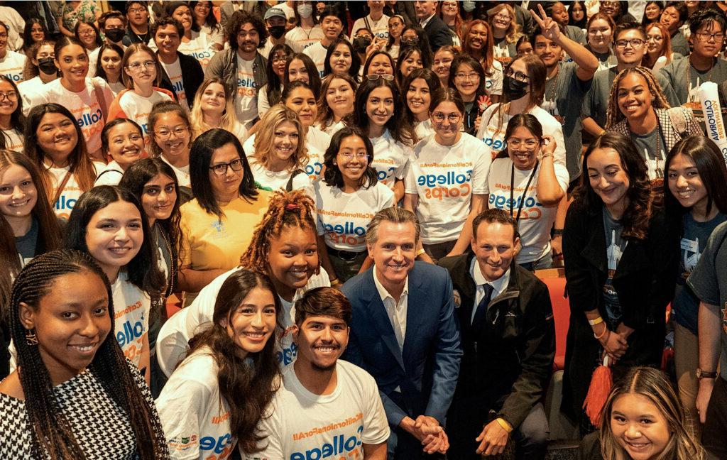 photo of a group of students posing to the camera with CA Governor Gavin Newson